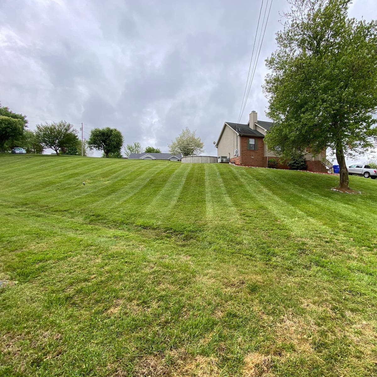 Hillside lawn mowed in even stripes